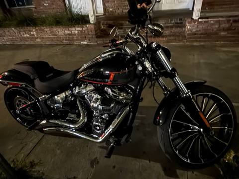 A black motorcycle photographed outdoors at night.